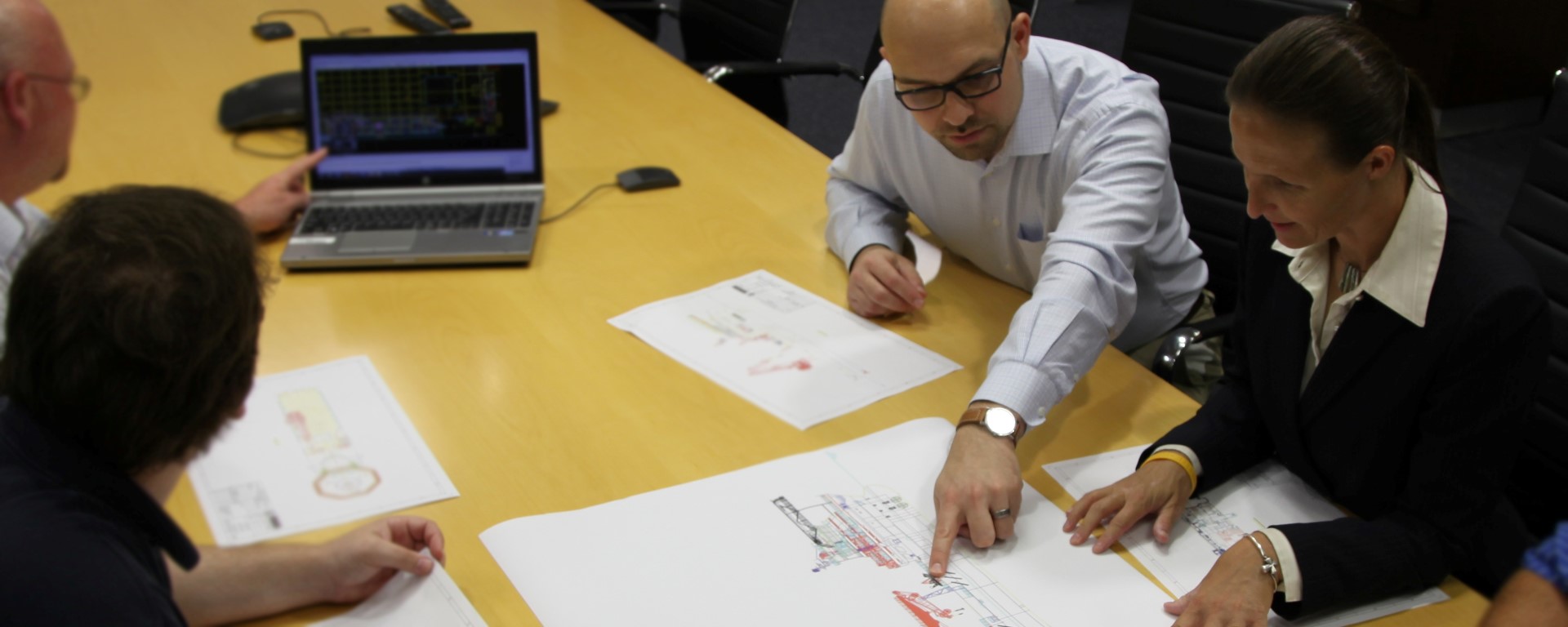 Filip Valica reviewing engineering drawings with a client team